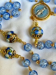 Handmade Blue Rosary For Jewelry Making, Blue Beaded Rosary As A Gift, Blue Glass Beads For Jewelry Making, Blue Glass Beads For Gift, Blue Glass Beads For Gifts, Blue Glass Spiritual Beads, Blue Round Spiritual Beads, Spiritual Blue Glass Beads, Blue Glass Polished Beads