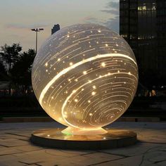 a large light up ball sitting on top of a sidewalk