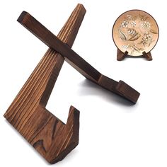 a small wooden object next to a piece of wood that has been carved into the shape of a cross