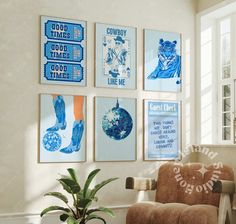 a living room with posters on the wall and a chair next to a potted plant