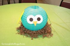 a paper lantern shaped like an owl sitting on top of a table