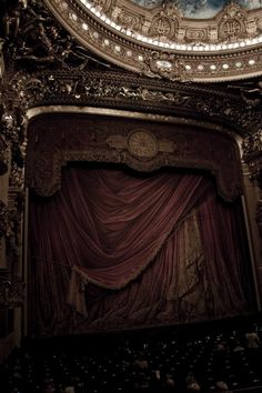 an ornately decorated stage with red curtains