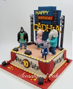 a birthday cake decorated with cartoon characters and musical notes