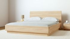 a bed sitting on top of a white rug next to a wooden headboard and foot board