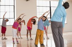 a group of children and adults in a dance class