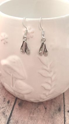 Cute ballet shoe earrings! The silver plated fishhook ear wires measure 3/4" x 7/10", and the silver plated pewter ballet shoe charms measure 7/10" x 3/10" (Total length is approximately 1 2/5") All items are lead and nickel free, message with any questions, thanks! Ballet Earrings, Shoe Earrings, Ballet Jewelry, Ballerina Jewelry, Ballerina Gift, Pointe Shoe, Ballet Shoe, Tyler Tx, Pointe Shoes