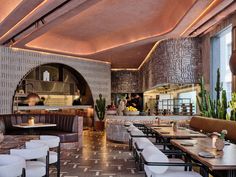 the interior of a restaurant with tables and chairs