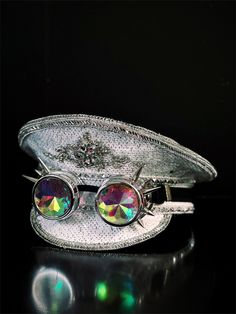 Our white sequin captain hat, adorned with silver trim, is your ultimate accessory for raves, festivals, and parties! The silver spiked goggles, featuring iridescent lenses, add an extra layer of style to your ensemble.


Age Group/Gender - Adult/Unisex

Size/Type - One size fits all adults

Color - Silver/White Silver Costume Hat For Carnival Party, Silver Carnival Party Costume Hats And Headpieces, Silver High Crown Costume Hats And Headpieces For Party, Silver Costume Hat With Round Crown For Parties, White Adjustable Costume Accessories For Party, Silver Costume Accessories For Halloween, Adjustable Silver Costume Hats And Headpieces For Festival, White Adjustable Costume Accessories For Carnival, Novelty Light-up Costume Accessories For Party