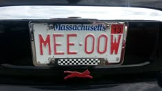 a close up of a license plate on the back of a car that says mee oow