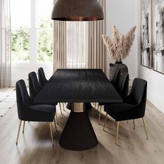 a dining room table surrounded by green chairs and a black round wooden table with gold legs