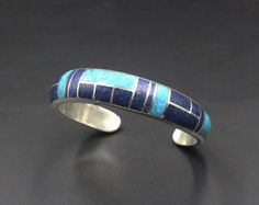 This is a heavy duty sterling silver cuff bracelet made with inlaid natural turquoise and natural lapis lazuli stone. The width is 12mm, tapering to 8mm. The thickness is 6 mm. The gap is 1.25 inches for a man's wrist size; 1 inch for a woman's wrist size. Select your wrist size from the drop down menu, and we will make your bracelet to fit. Please measure your wrist size if you are unsure of the size. Solid sterling silver and stone inlay bracelets cannot be changed. No returns are accepted unl Howlite Bracelet, Lapis Lazuli Bracelet, Mens Gold Bracelets, Turquoise Bracelet Cuff, Gold Bead Bracelets, Turquoise Cuff, Jade Bracelet, Sterling Silver Cuff Bracelet, Mens Beaded Bracelets