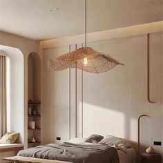 a bed sitting under a light fixture in a bedroom