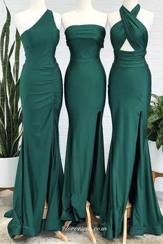 three green bridesmaid dresses on mannequins in front of a potted plant