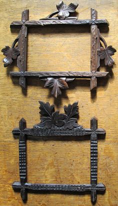 an old wooden frame with flowers and leaves on it