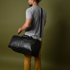 GUARANTEED CHRISTMAS DELIVERY ON ORDERS PLACED BEFORE THE 19TH OF DEC. This leather duffel bag seamlessly blends timeless elegance with durable functionality, making it the perfect companion for every occasion. Whether it's a quick getaway, a stylish weekend trip, or a visit to the gym, this versatile carry-on bag will go with you anywhere. Crafted from soft full-grain leather, reliable YKK Zipper and rust free antique brass fittings and studs, it exudes sophistication. With its optimal size, abundance of pockets, lightweight and flexible design, and a removable shoulder strap, this bag is an ideal choice for all your travel needs. DIMENSIONS-  Length: 51 cm/ 20 inches  Height: 28cm / 11 inches Depth:  28cm / 11 inches ► DELIVERY: Same Day Shipping.Free Express Delivery in 4-6 working days Black Leather Trim Travel Bag For Business, Black Bags With Leather Trim For Overnight Trips, Black Leather Trim Duffle Bag For On-the-go, Black Duffle Bag With Leather Trim Satchel, Classic Black Duffle Bag With Leather Handles, Black Duffle Bag With Leather Handles For On-the-go, Black Leather Travel Bag With Leather Trim, Black Leather Trim Duffle Bag For Everyday, Black Duffle Bag With Leather Trim For Everyday Use