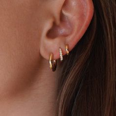 14k single solid gold hoop with faceted back. This earring is made to delicately remind you of your goddess power. Pictured on model in third piercing. These are the smaller version of our Solid Goddess Hoops. Tiny Hoop Cartilage Earrings, Yellow Gold Huggie Cartilage Earrings, Yellow Gold Pierced Cartilage Earrings, Minimalist Huggie Earrings With Halo, 14k Gold Earrings With Halo, 14k Gold Filled Hoop Cartilage Earring, Single 14k Gold-filled Hoop Cartilage Earring, Minimalist Yellow Gold Hoop Earrings With Halo, Minimalist Yellow Gold Halo Hoop Earrings