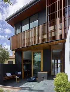 a modern house with wooden balconies on the balcony