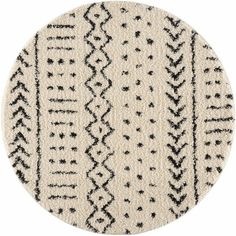 a round rug with black and white designs on it