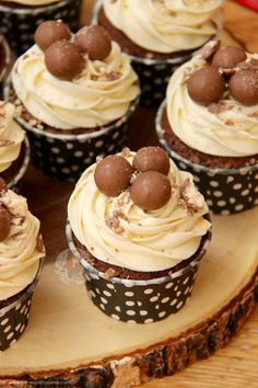 cupcakes with white frosting and chocolate decorations