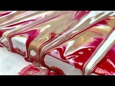 red and gold wrapping paper sitting on top of a white tablecloth covered in foil