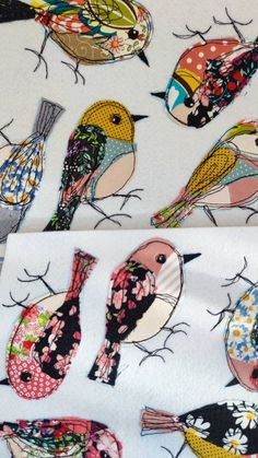 several colorful birds on white fabric with polka dots