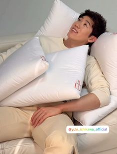 a man laying on top of two pillows