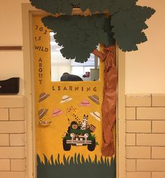 a classroom door decorated with an image of a car and trees on it, as well as the words learning