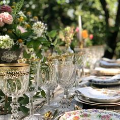 the table is set with glasses and plates