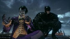 two batman characters sitting on top of a roof in the dark knight video game,