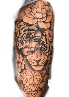 a man's arm with a tiger and flower tattoo on the left side of his body