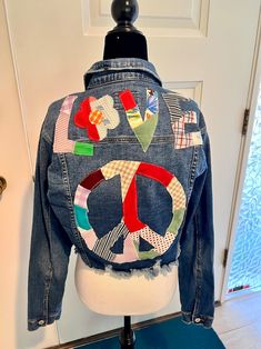 a jean jacket that has been altered to look like the peace sign is on top of a mannequin