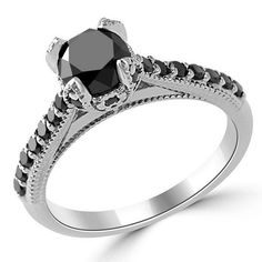 a black diamond engagement ring on a white background