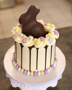 there is a chocolate bunny on top of the cake, and it's ready to be eaten