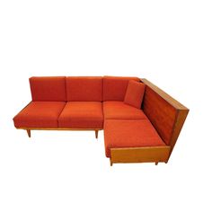 an orange sectional couch with wooden legs and arm rests on a white background, it appears to be made from wood