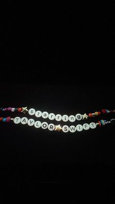 two bracelets with words on them in the dark