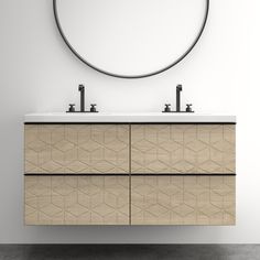 a bathroom vanity with two sinks and a round mirror above it, in front of a white wall