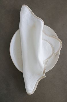 three white napkins sitting on top of a plate