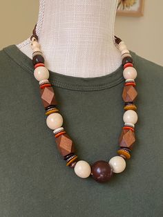 This natural beauty features neutral tone beads that are made with mixed materials including tagua, bombona seeds, wood beads.  Pair it with a solid top and jeans for high impact. Wooden Necklaces, Seed Jewelry, Wood Beads Jewelry, Maasai Mara, Jewelry Chunky, Tagua Jewelry, Beauty Features, Yellow Necklace, Masai Mara