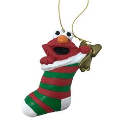 an ornament shaped like a christmas stocking with eyes and nose on it