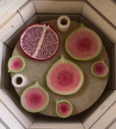 a table topped with plates and bowls filled with fruit