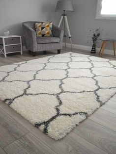 a living room with a chair and rug on the floor