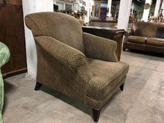 a brown chair sitting on top of a cement floor