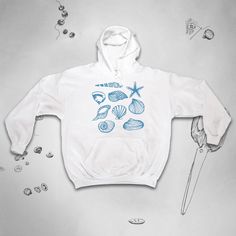 It's Gildan adult unisex hooded sweatshirt (hoodie) with a durable print, based on the high quality earth friendly ink from Epson.  Hoodie details: - 50% cotton, 50% polyester - Double-lined hood - Pouch pocket; matching drawcord - Pill-resistant air jet yarn - Set-in sleeves - Taped shoulder-to-shoulder - Double-needle stitching throughout - Tear-away label - 1x1 ribbed cuffs and waistband with spandex - Non-toxic inks - Made with 50% sustainably and fairly grown USA cotton The size system is A Blue Seashells, Graphic Design Aesthetic, Trendy Graphic Design, Hoodie Details, Gray Hoodies, Aesthetic Blue, Design Aesthetic, Earth Friendly, Beach Summer