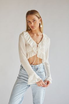 white long sleeve tie front top with ruffle detailing | white blouses for spring | white going out tops Billowy Long Sleeve Top For Summer, Cropped Ruffle Hem Top For Day Out, Spring Long Sleeve Tops With Ruffle Hem, Cropped Ruffled Blouse For Day Out, Cropped Ruffle Blouse For Day Out, Spring Billowy Ruffle Blouse, Billowy Ruffled Blouse For Spring, Spring Billowy Ruffled Blouse, Spring Billowy Blouse With Ruffles