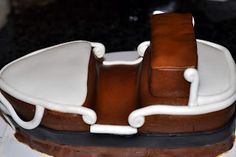 a chocolate cake with white icing sitting on top of a table