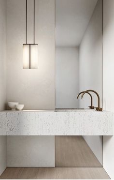 a bathroom sink sitting under a mirror next to a faucet mounted on a wall