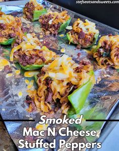 cooked stuffed mac n cheese stuffed peppers on a baking sheet with text overlay that reads smoked mac n cheese stuffed peppers