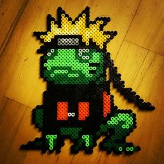 a pixellated image of a green monster with a crown