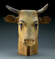 a wooden sculpture of a bull's head with horns