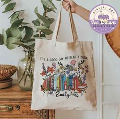 a person holding a bag that says it's a good day to read a book